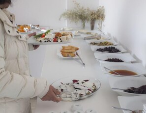 A buffet table with various food items, including a plate with a salad, a bowl of mixed nuts, and several small dishes with different foods. - Ferah Hotel (Kaş)