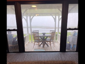 Relax in a serene outdoor seating area overlooking a tranquil body of water.