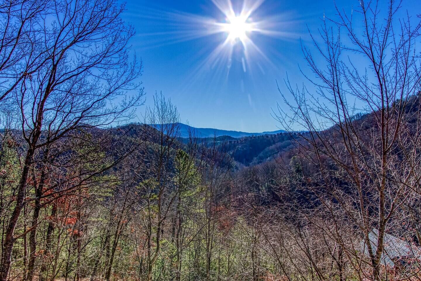 A mountainous landscape with clear skies and sunlight.
