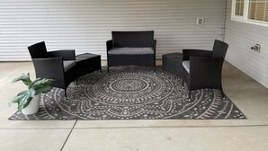A patio area with a round rug, two chairs, and a small table. - Spacious and Peaceful (College Place)