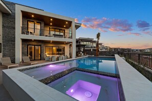 A modern two-story house with a swimming pool, outdoor seating, and a balcony. - ALBATROSS SOUTH at Copper Rock! (Hurricane)