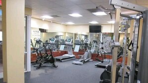 A gym with multiple treadmills, stationary bikes, and weight machines.