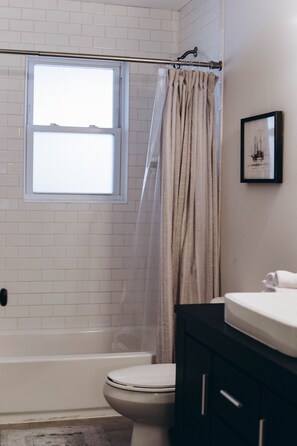 Bathtub, hair dryer, towels, soap