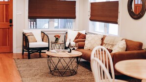 A cozy living room with a brown sofa, two armchairs, a coffee table, and a patterned rug. - Outdoor Oasis in Historic St. Augustine (Saint Augustine)