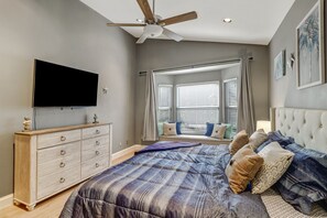 A bedroom with a bed, a dresser, a television, a ceiling fan, and a window with blinds. - Pool Home Near Beaches and Downtown 5th Ave. (Naples)