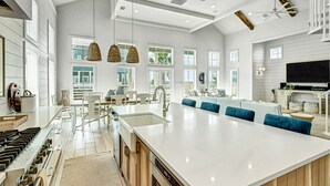A spacious kitchen with a large island, modern appliances, and pendant lighting. - Stunning Palmilla Beach home with gulf views, private pool, and golf (Port Aransas)