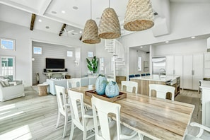Enjoy a spacious interior with a large dining table, kitchen area, and seating.