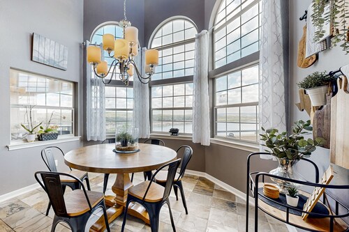 Lavish lakefront retreat in private island community with pools, tennis, & gym