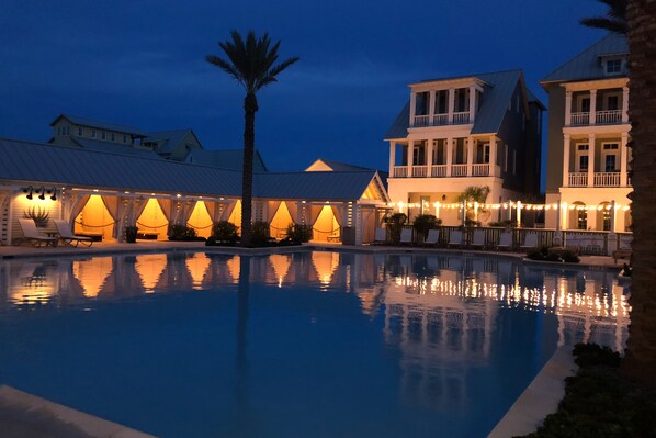 Relax by the serene pool surrounded by colonial-style buildings with balconies.