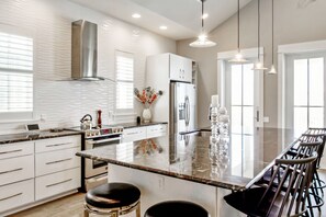 Enjoy cooking in this well-lit kitchen with ample workspace and seating.
