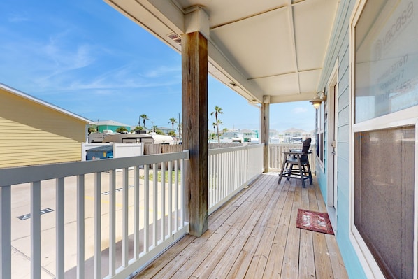 Guests can enjoy an outdoor seating area with a deck and a chair, offering a view of the surrounding area.