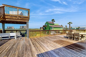 Enjoy a serene view from this elevated deck with a table and chairs, perfect for relaxing.