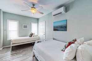 Relax in this stylish single-bedroom retreat with a large bed, ceiling fan, and air conditioning for a comfortable stay.