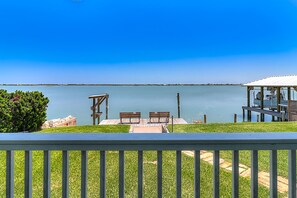 Relax on the lakeside deck with a serene view, enjoy dining and seating areas, and take refuge in the shaded covered space.
