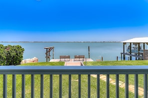 Relax on the lakeside deck with a serene view, enjoy dining and seating areas, and take refuge in the shaded covered space.