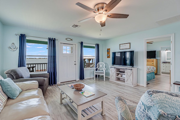 Relax in a comfortable living space with a sofa, armchairs, and a dining table.
