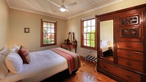 A bedroom with a bed, dresser, and a mirror. - Telegraph Station (Gulgong)