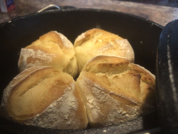 Four loaves of bread in a baking dish.