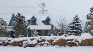 A two-story house with a snow-covered roof and a visible power line tower. - The Chick Inn<br>Bed Breakfast and Dinner!!! (Eagle Mountain)