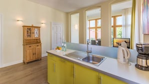 A modern kitchen with a large window, a built-in sink, and a coffee maker.