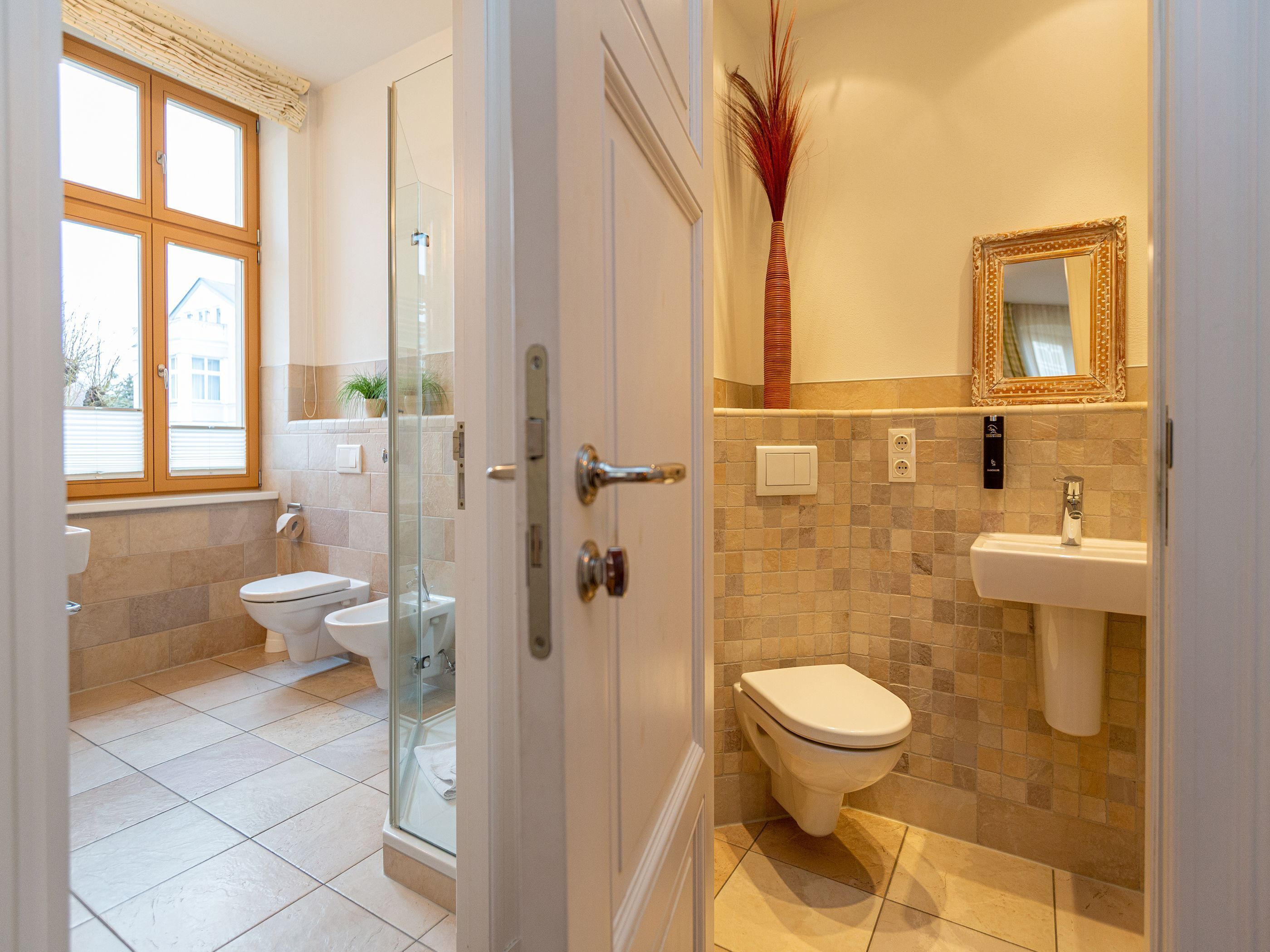 A bathroom with a toilet, sink, and shower area.