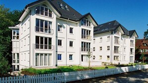 A modern multi-story residential building with balconies, large windows, and a white exterior. - Villa Strandperle, App. 32a (Heringsdorf)