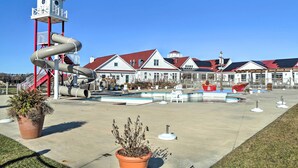 A public park with a water slide, a swimming pool, and a building with red roofs. - Modern Lewes Home w/ Deck, Grill + Pond View! (Lewes)