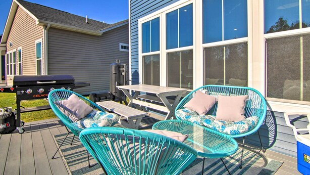 A deck with two turquoise wicker chairs, a picnic table, and a barbecue grill. - Modern Lewes Home w/ Deck, Grill + Pond View! (Lewes)