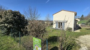 A small building with a beige exterior, a fenced area with a sign, and a clear blue sky. - Cozy House in Périgord Noir with Garden (Cénac-et-Saint-Julien)