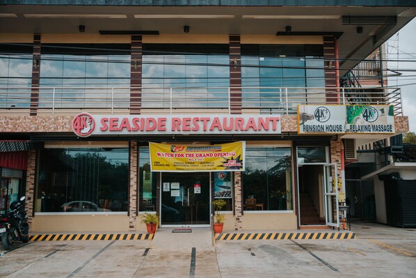 A restaurant with a sign reading "4K SEASIDE RESTAURANT" and a banner advertising a grand opening. - 4k's Pension House by Cocotel (Bogo)