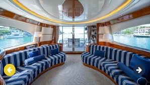 A luxurious interior with a curved seating area, large windows, and a view of the water. - Luxury Italian Megayacht (Fajardo)