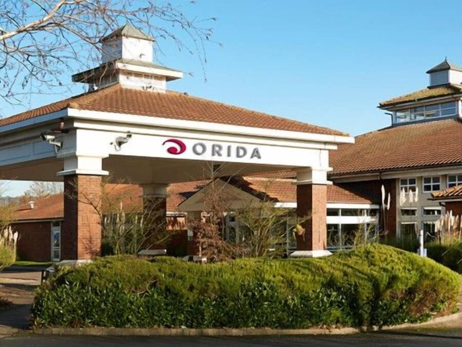 A building with a covered entrance and the name 'ORIDA' on the facade.
