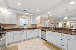 Enjoy cooking in this well-equipped kitchen with a sink, dishwasher, and coffee maker.