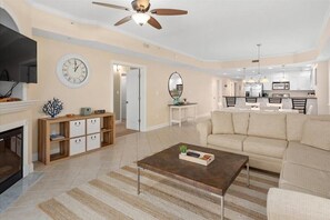 Relax in this inviting living area with a comfortable sofa, coffee table, and dining set.