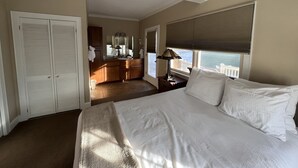 Una camera da letto con un letto grande, un comodino, una lampada e vista esterna.
