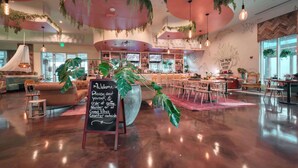 A spacious coffee shop with a modern interior, including a large seating area, a counter, and a sign that reads 'The Palm's Coffee House.' - Palms of Destin|12th flr Jr Suite-Lagoon Pool|Views (Destin)