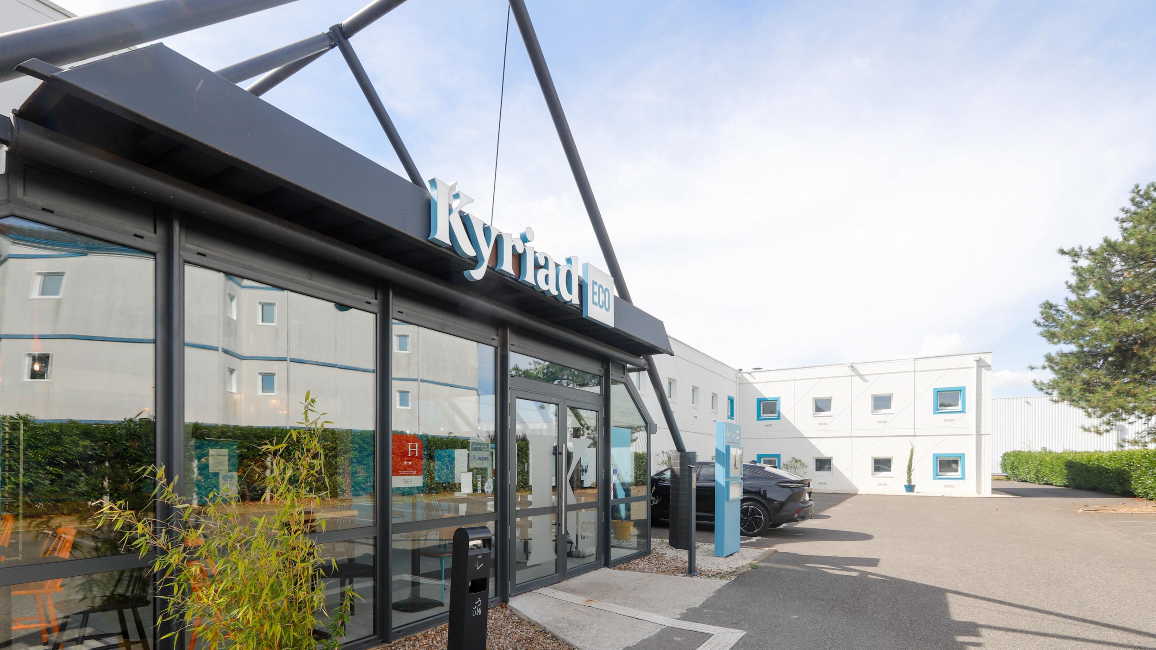 A building with a sign reading 'Kyriad ECO'.