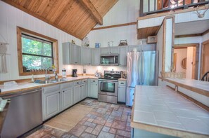 Enjoy cooking in this well-equipped kitchen with a microwave, oven, and refrigerator.