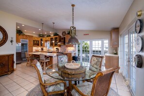 Enjoy meals and gatherings in this kitchen with a central island, refrigerator, sink, and ample counter space.