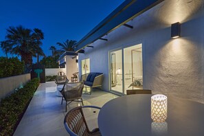 An outdoor patio with a round table, wicker chairs, and a built-in grill. - Family Luxury, Mountain views, Pool/Hot Tub, (Palm Springs)