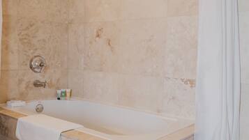 Une salle de bain équipée d’une baignoire, d’une douche et d’un porte-serviettes.