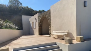 A modern outdoor patio with a stone bench, a set of stairs, and a stone wall. - 2-standing seaside villa, breathtaking view of the Gulf of Saint Florent (Saint-Florent)