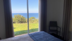 A room with a bed, a chair, and a view of the sea through a window. - 2-standing seaside villa, breathtaking view of the Gulf of Saint Florent (Saint-Florent)