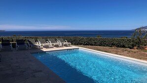 A swimming pool with lounge chairs and a view of the ocean. - 2-standing seaside villa, breathtaking view of the Gulf of Saint Florent (Saint-Florent)