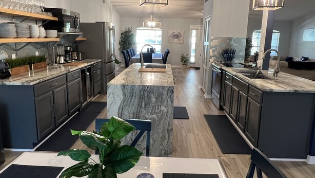 A modern kitchen with a central island, dark cabinetry, and pendant lighting. - LARGE MODERN 4 BEDROOM HOME. VERY PRIVATE w HOT TUB & 3 acres!  (Crystal River)