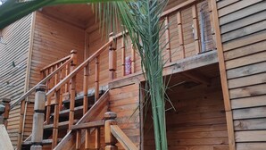 A wooden staircase with a handrail leading to a balcony. - Karabibik Bungalow (Demre)