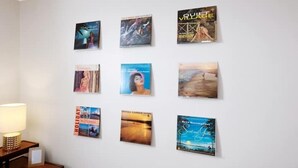 A wall with nine framed items, including books and magazines, arranged in a grid pattern. - 70's Boho 1 BR Near Zoo/Liberty Bowl/BBQ Fest!! (Memphis)