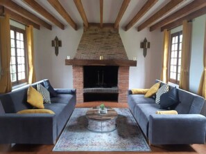 A living room with two sofas, a fireplace, and a coffee table. - 3-Bedroom Private Vacation Home in ROSAY SUR LIEURE (ROSAY SUR LIEURE)
