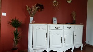 A white cabinet with ornate handles against a red wall, accompanied by a potted plant and decorative mirrors. - 3 Bedroom Private vacation home in ROSAY SUR LIEURE (ROSAY SUR LIEURE)