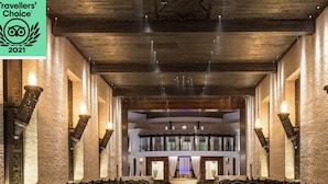 Eine geräumige Lobby mit einer zentralen Sitzgelegenheit, hohen Decken und einem modernen Design.